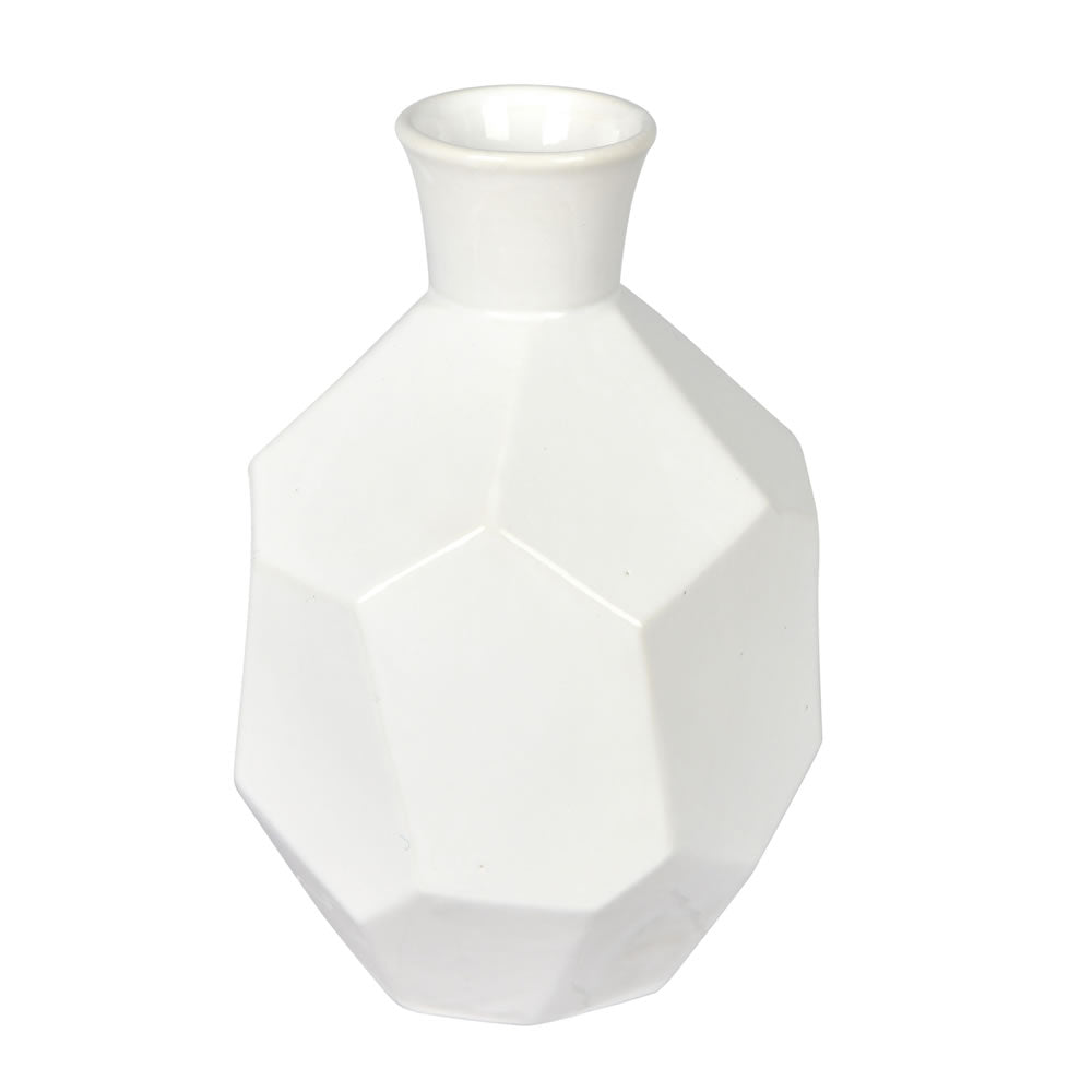Vickerman 10" White Ceramic Geometric Bottle. This bottle mixes together touches of whimsical and modern. This ceramic bottle has a geometric body and a sleek neck. This bottle can stand on its own or pair with any faux floral to add a pop of color. It me