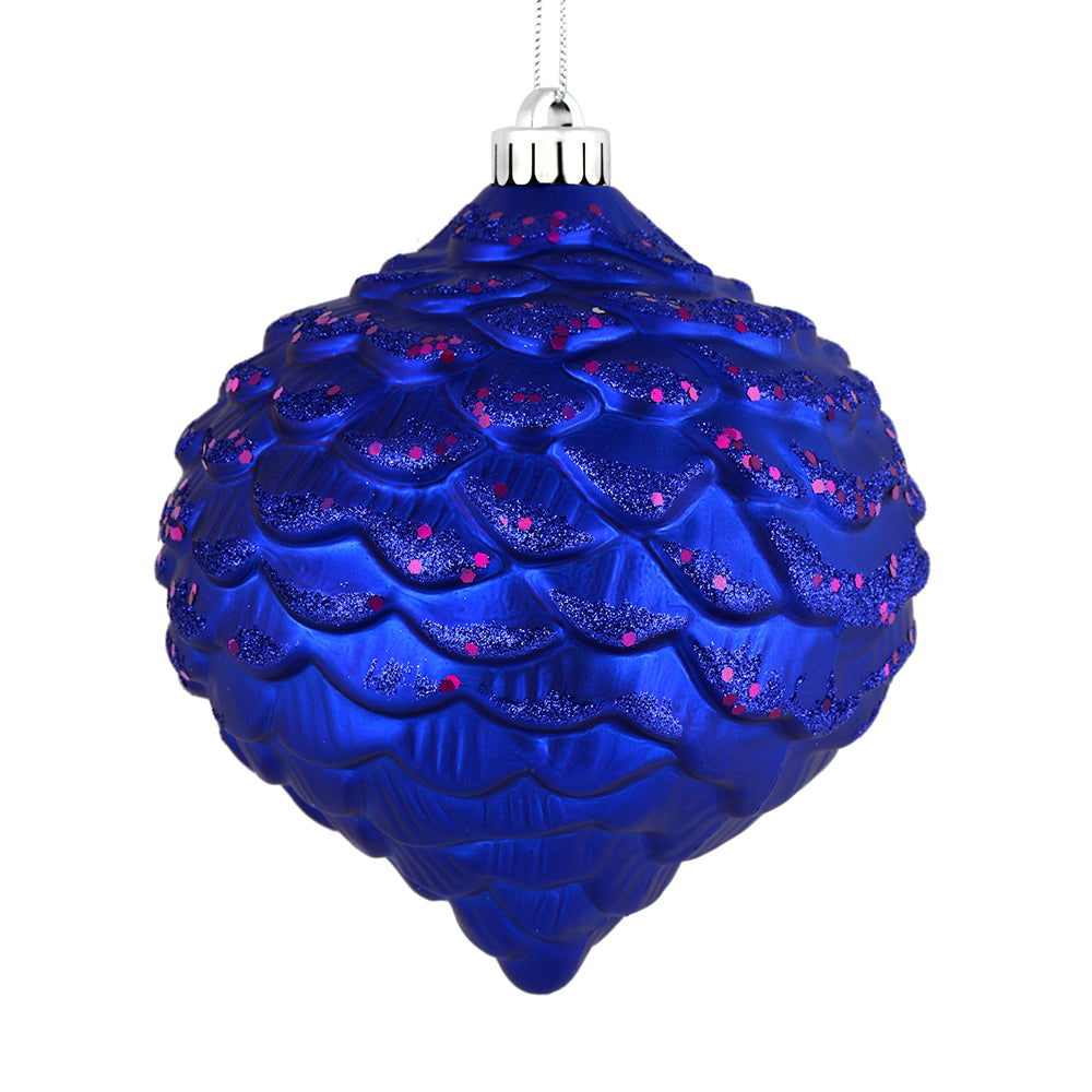 Vickerman 6" Cobalt Blue Glitter Ornament. This ornament features a matte embossed top with glitter accents and a shiny bottom. The variety of finishes on this ornament creates elegance that will complement any holiday decorating project. Made with shatte
