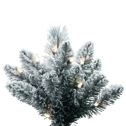 Vickerman 9' x 46" Flocked White Pine Artificial Slim Pre-lit Christmas Tree with 750 Dura-Lit® Warm White LED Mini Lights. It measures 108 inches tall and 46 inches wide, which is considered a slim profile. This tree boasts 1258 tips for a realistic look