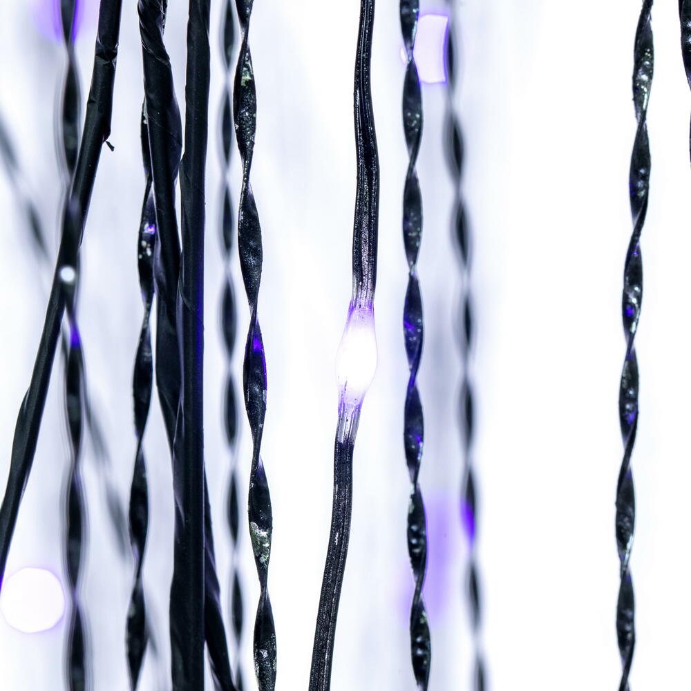 Vickerman 6' x 38" Black Willow Twig Artificial Pre-Lit Halloween Tree with 243 Purple and Orange LED Dot Lights. It measures 72 inches tall, and 38 inches wide, with the branches shaped about parallel to the floor. Pre-lit with 243 Dot LED Lights, the li