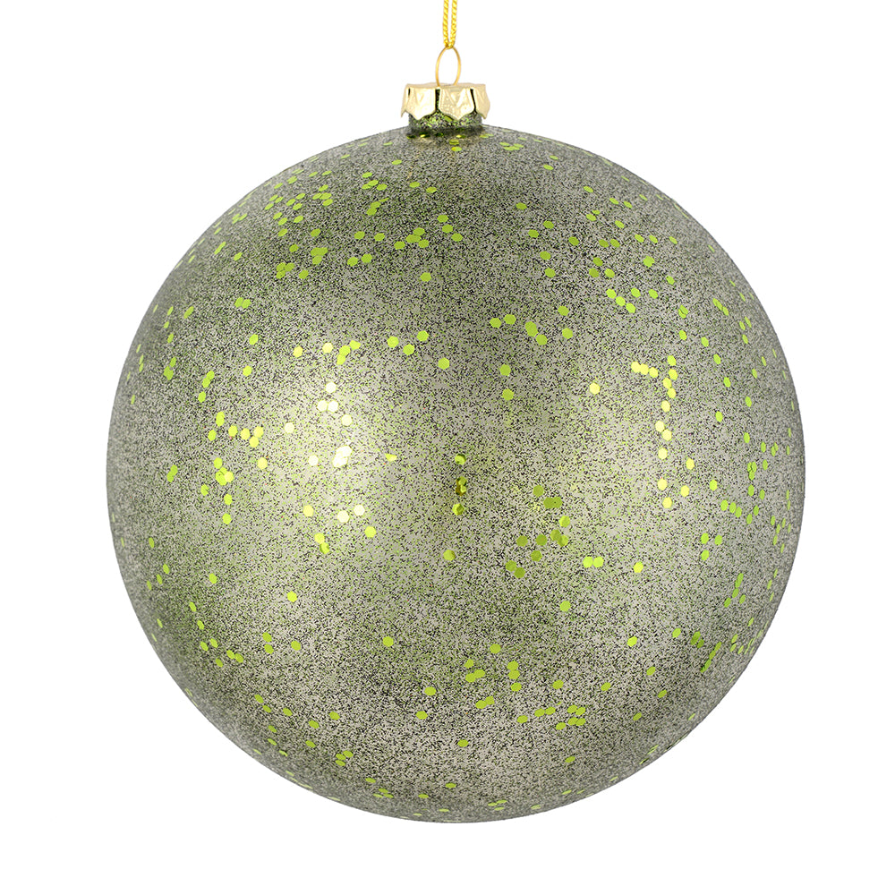 Vickerman 4.75" Moss Green Glitter Clear Ball. This ornament features a clear complexion with a dusting of moss green glitter inside. Add a touch of glam to any holiday arrangement with this delicate looking ornament. Made with shatterproof plastic. Inclu