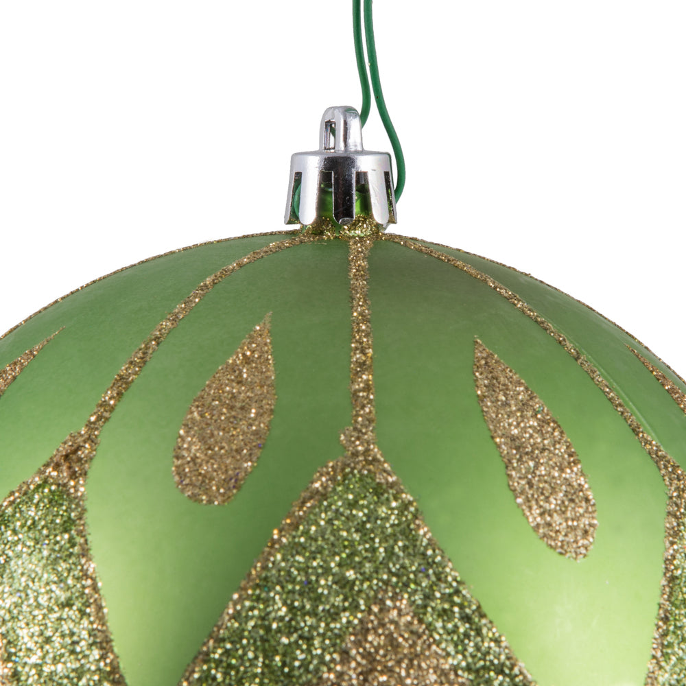 Vickerman 4.75" Celadon Matte Ball with Glitter Diamond Pattern. Add variety and sparkle to your holiday arrangement with this matte ornament that features a glitter pattern. Includes 4 pieces per bag. Made with shatterproof plastic. Ornament has a drille