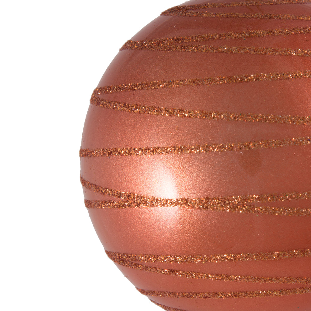 Vickerman 3" Coral Candy Finish Ball with Glitter Lines. Add some sparkle to your holiday decorating project with this candy finish ornament that features a glitter line pattern. Includes 6 pieces per bag. Made with shatterproof plastic. Ornament has a dr