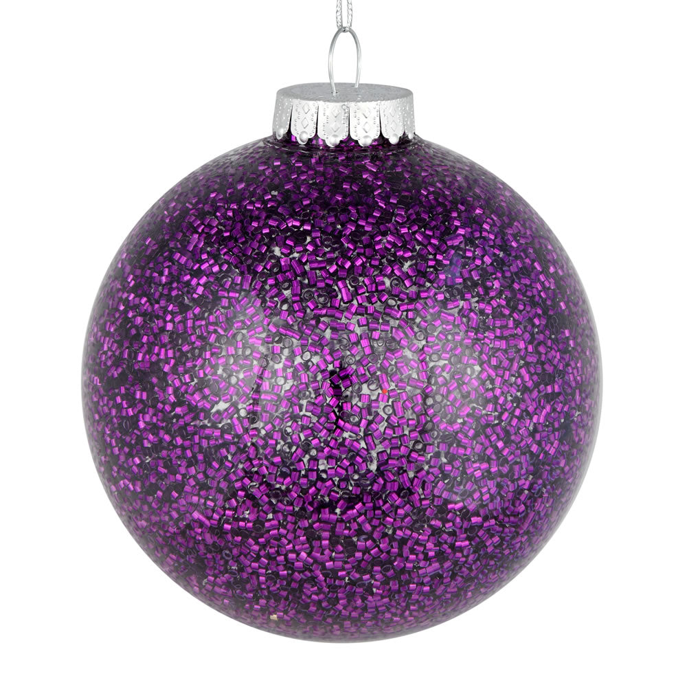 Vickerman 6" Plum Tinsel Clear Ball Orn 4/Bag. This clear ball features colored glitter and tinsel on the inside. Add some sparkle to your holiday decorating projects with this tinsel ornament. Made with shatterproof plastic to reduce the likelihood of br