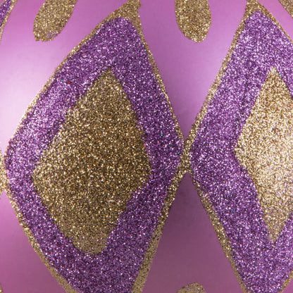 Vickerman 4.75" Orchid Matte Ball with Glitter Diamond Pattern. Add variety and sparkle to your holiday arrangement with this matte ornament that features a glitter pattern. Includes 4 pieces per bag. Made with shatterproof plastic. Ornament has a drilled