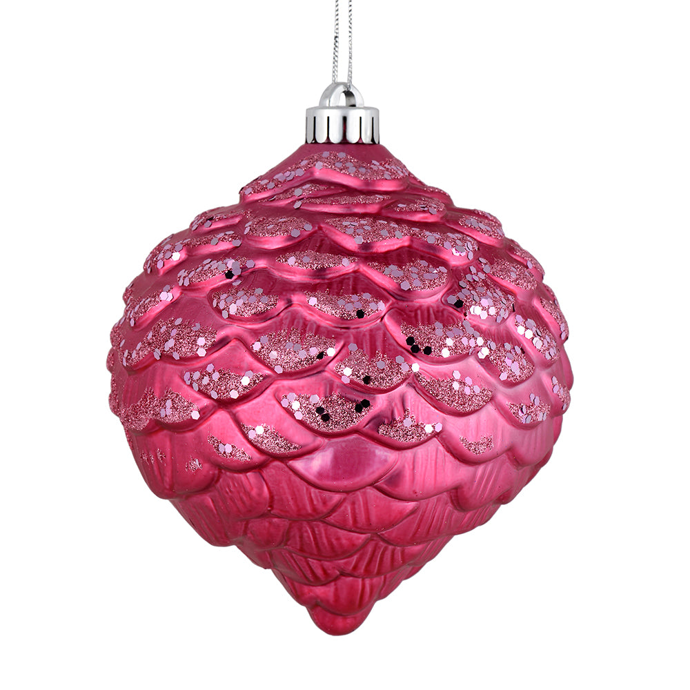 Vickerman 6" Mauve Glitter Ornament. This ornament features a matte embossed top with glitter accents and a shiny bottom. The variety of finishes on this ornament creates elegance that will complement any holiday decorating project. Made with shatterproof