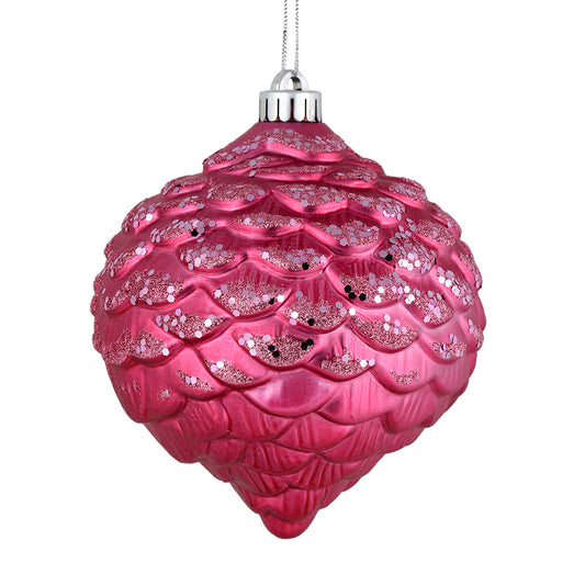 Vickerman 6" Mauve Glitter Ornament. This ornament features a matte embossed top with glitter accents and a shiny bottom. The variety of finishes on this ornament creates elegance that will complement any holiday decorating project. Made with shatterproof