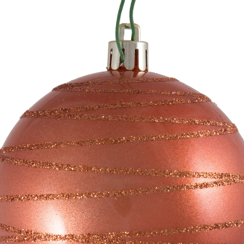 Vickerman 3" Coral Candy Finish Ball with Glitter Lines. Add some sparkle to your holiday decorating project with this candy finish ornament that features a glitter line pattern. Includes 6 pieces per bag. Made with shatterproof plastic. Ornament has a dr