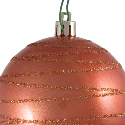 Vickerman 3" Coral Candy Finish Ball with Glitter Lines. Add some sparkle to your holiday decorating project with this candy finish ornament that features a glitter line pattern. Includes 6 pieces per bag. Made with shatterproof plastic. Ornament has a dr