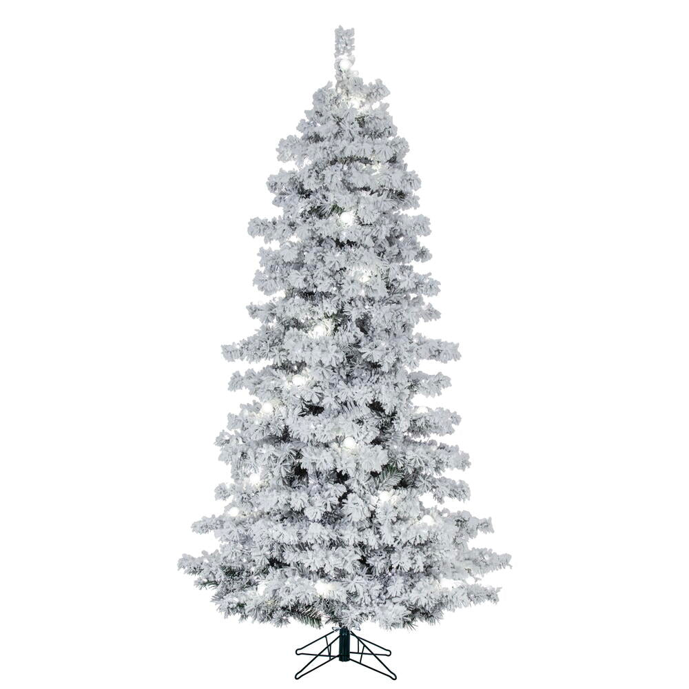 Vickerman 12' x 74" Flocked Slim Alaskan Artificial Pre-Lit Christmas Tree with 91 Pure White G40 and 1450 Pure White LED Mini Lights, 3774 Flocked Realistic PVC Tips, 6' Step On/Off Power Cord and Folding Metal Tree Stand. Assembly is required.