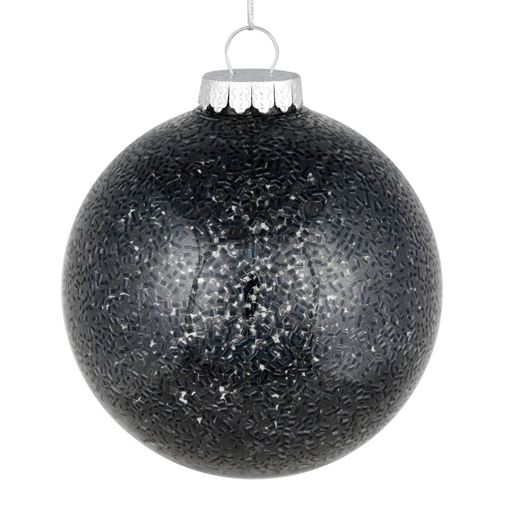 Vickerman 6" Black Tinsel Clear Ball Orn 4/Bag. This clear ball features colored glitter and tinsel on the inside. Add some sparkle to your holiday decorating projects with this tinsel ornament. Made with shatterproof plastic to reduce the likelihood of b